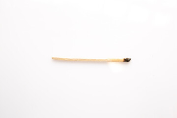 Burnt wooden matches horizontally on white background.