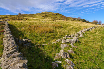 dry stone wall under a vivid blue sky on a mountain top in north wales