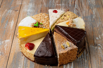 Sampling of different kinds of cake slices on wooden table, top view © Tkachenko Alexey