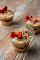 Organic chia seeds trifle with mango and passion fruit, decorated with fresh strawberries