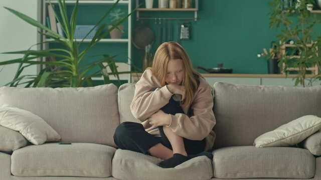 A Depressed and Desperate Red-haired Teenage Girl in Stress, Holding a Bottle of Pills. The Problem of Bullying, Psychological Abuse in Social Networks. Cyberbullying. Mental Health.
