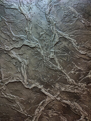 Rough texture of decorative putty in dark colors.