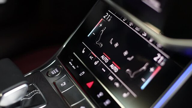 The panel of various buttons a in a modern car. LCD screen of climate control, gearshift and virtual cockpit