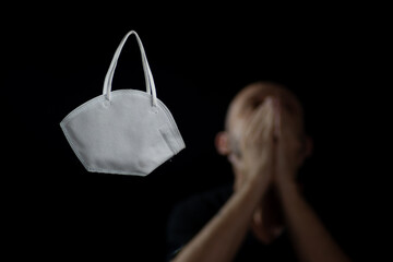 Face protection mask that protects against coronavirus contamination. Anxiety caused by quarantine and covid-19 deaths.