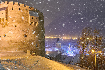 Christmas Tree in the old city center of Brasov in a snowing night,Panoramic view of the old town...