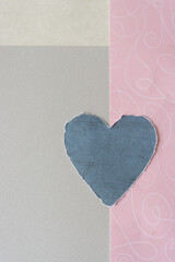 blue heart on pink and gray paper