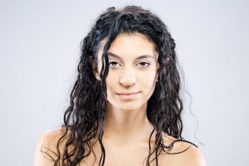 Beautiful brunette girl with long wet hair, studio portrait