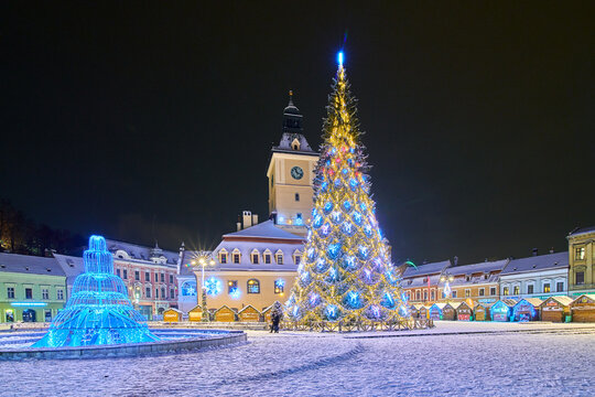 Brasov, Romania- 06 January 2019:Christmas Tree in the old city center of Brasov in a snowing night,Panoramic view of the old town and  Council Square