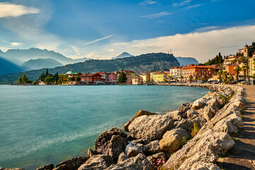 Fototapeta premium Panorama of Torbole a small town on Lake Garda, Italy. Europa..Soft focus due to long exposure shot,beautiful Lake Garda surrounded by mountains in the summer time