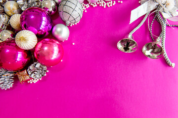 Christmas balls and ornaments on a pink background