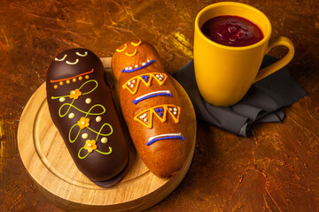 White and brown guaguas de pan with colada morada. Ecuadorian traditional food on the day of the...
