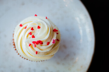 Beautiful delicious cupcakes with pink hearts top of view