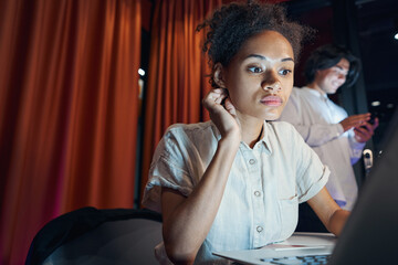 American woman working on laptop on workplace