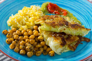 Tasty leaves of cabbage in batter and garbanzo with red and green sauces at plate