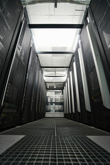 Server racks standing in hallway of data center