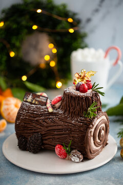 Yule log chocolate cake with frosting for Christmas
