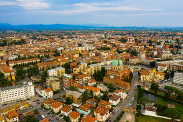 Fototapeta na wymiar Aerial view of Udine cityscape overlooking residential areas and ossuary temple of Fallen of Italy (Tempio ossario) in autumn day