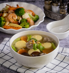 Tofu soup with minced pork in a white plate