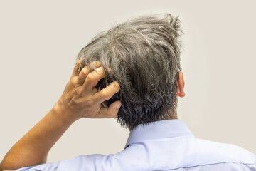 Back view of senior man scratching head