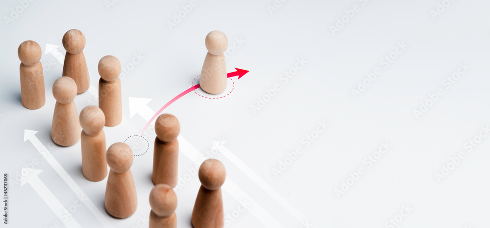 Poster the wooden figure standing on red arrow, change direction and pointing in a different way from group
