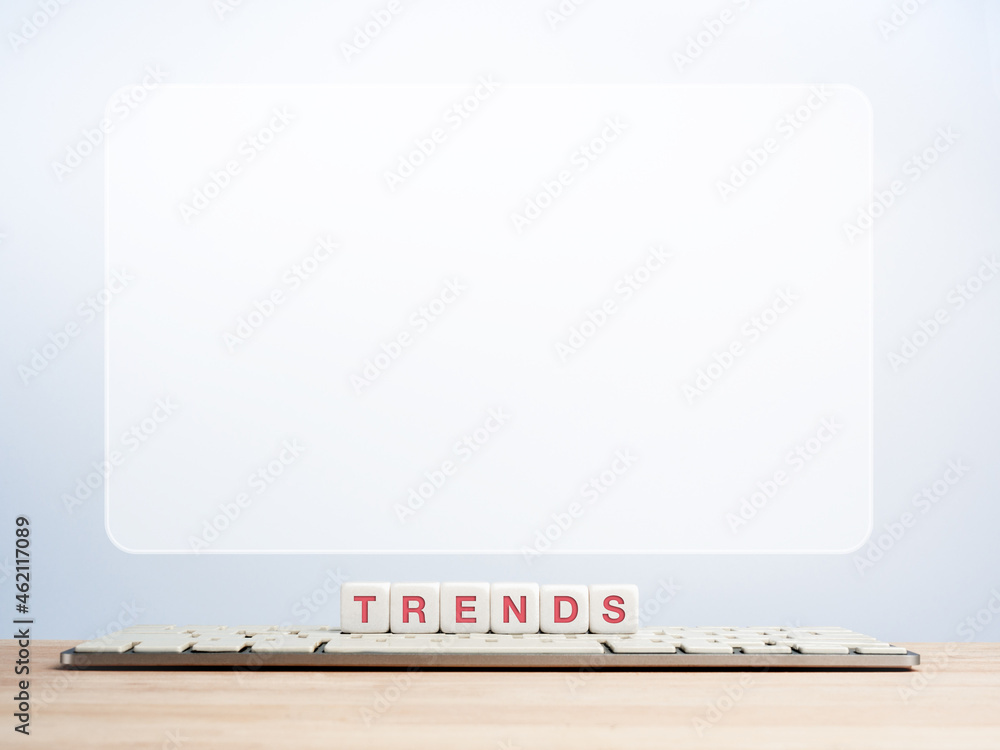 Aufkleber trends business concept. words, trends on white cube blocks, computer keyboard on wooden desk with b
