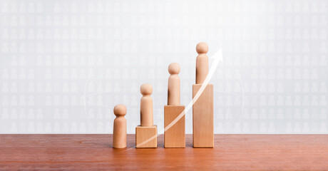 Population growth concept. Rising up arrow and wooden figures standing on a growing graph chart...