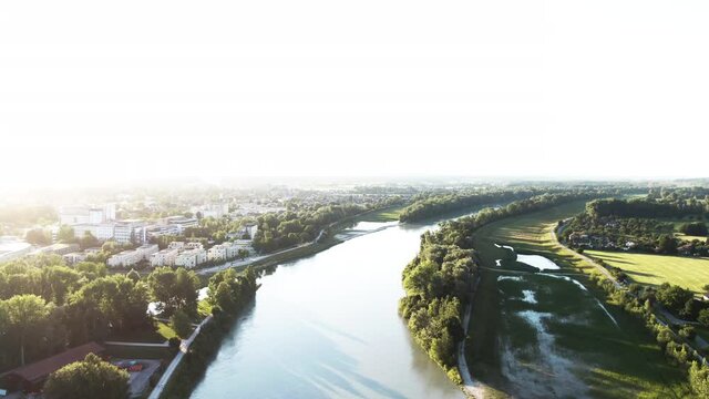 Aerial shot in the sunset of the mangfall river and next to it
the cityscape of Rosenheim with a lot of green nature and