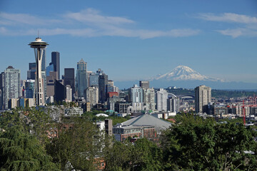 Seattle, WA / USA - June 23, 2021: Downtown buildings and Mt. Rainier are shown in a wide view during a summer day.