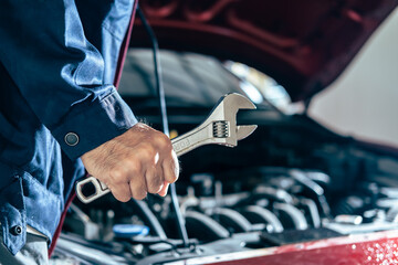 Asians Man medical protect protection mask face mask mechanic inspection hold wrench for fix blue car for service maintenance insurance with car engine bonnet car.for transport automobile automotive