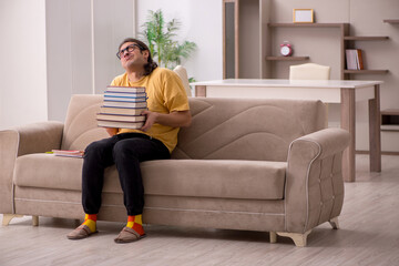 Young male student preparing for exams at home