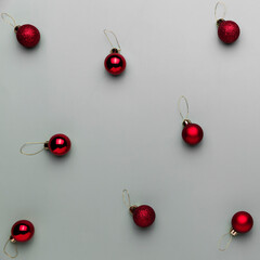 Naklejka na ściany i meble Pattern on gray background with small red Christmas balls, sphere fir tree toys