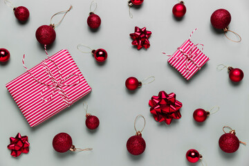 Gray background with two pink Christmas gift boxes, red ball toys, spheres, bows