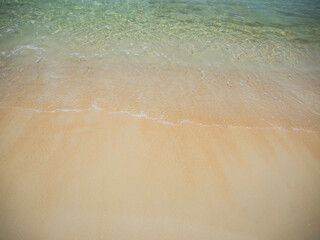 Soft ocean wave on a beautiful sandy beach