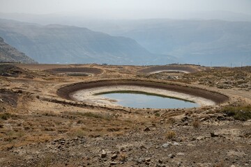 half empty water reservoir pond in the Lebanon mountain region of Laqlouq