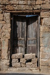 damaged old entrance door to a Mediterranean stone house in the Lebanon city of Batroun