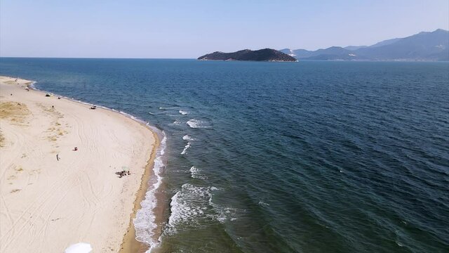 Slow motion aerial clip over  a tropical beach with golden sand in the area of Keramoti, Kavala, in Northern Greece in 4k