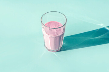 Homemade blueberry or currant smoothie fruits or yogurt on pink background. Concept of proper nutrition and healthy eating. Organic and vegetarian drink.