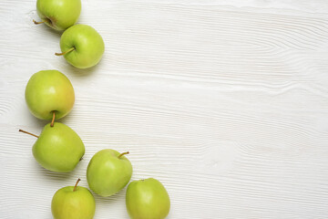 Green apples on the white table. Top view,