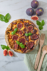 Home made autumn quiche with pumpkin and figs on a table