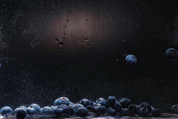 Water drops on ripe sweet blueberry. Fresh blueberries background with copy space for your text. Vegan and vegetarian concept.