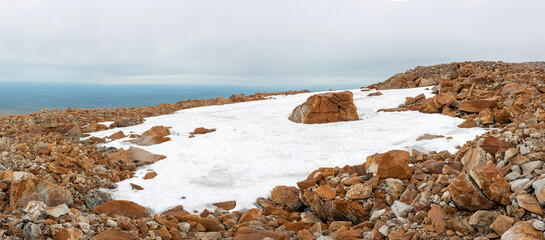 A stone plateau with non-melting snow, even in summer. Climb before the main peak of the Polar Urals. Tracking.