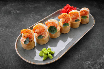 Sushi rolls with omelet, shrimps and crab sticks
