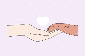 Human hand hold dog paw show care and love for animals. Person and pet friendship. People caring about puppies and cats. Flat vector illustration. Adoption and shelter, charity, volunteer concept.  © drawlab19