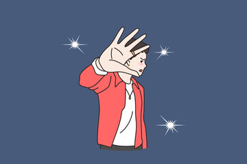 Unhappy young man celebrity annoyed by camera flashes photographers making. Distressed angry male star bothered reporters journalists, make stop hand gesture. Flat vector illustration.