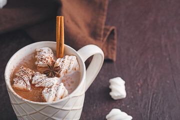 Cup of hot cocoa drink with marshmallows on dark background, closeup