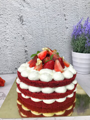Red velvet cake with cream cheese frosting and strawberries