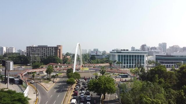 Top view of drone flying over the main street maximo gomez in the city of santo domingo, light traffic with cars waiting for traffic light.