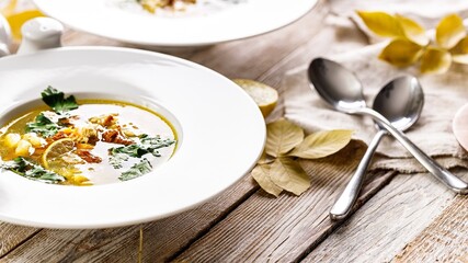 Food still life. Delicious autumn soup with chanterelles and fresh herbs. Seasonal dish with edible mushrooms. Organic food. Food banner