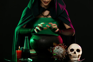 Witch performing ritual on black background