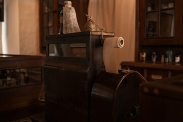 Vintage cash register in old pharmacy. Wooden antique furniture for medical drug storage